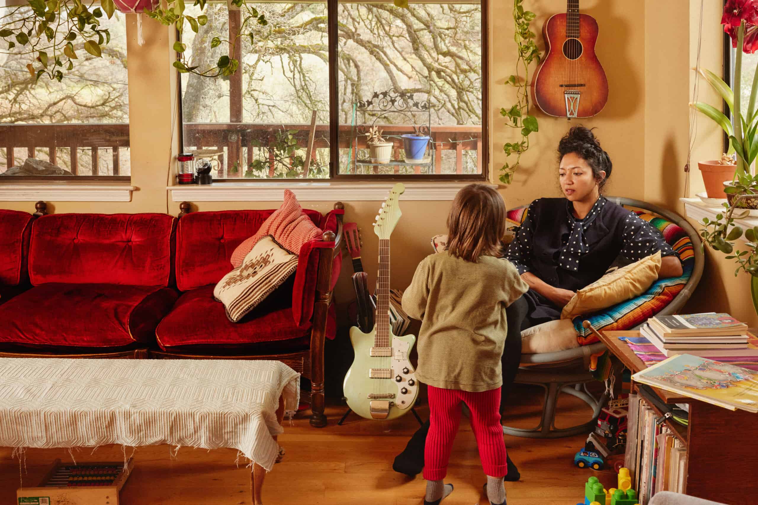 Free Photo  Mother and father playing with son or daughter in rocking  chair on light room floor with kitchen set on background, happy family  spending time together, playing with baby.